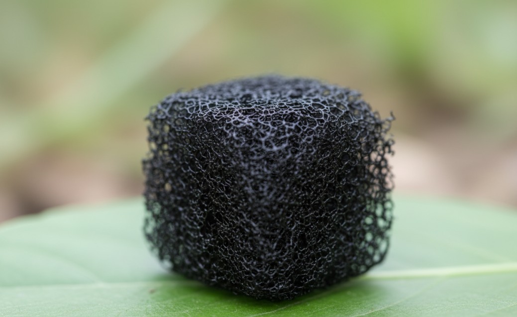 Ultra-low-density carbon nanotube aerogel placed on a leaf.