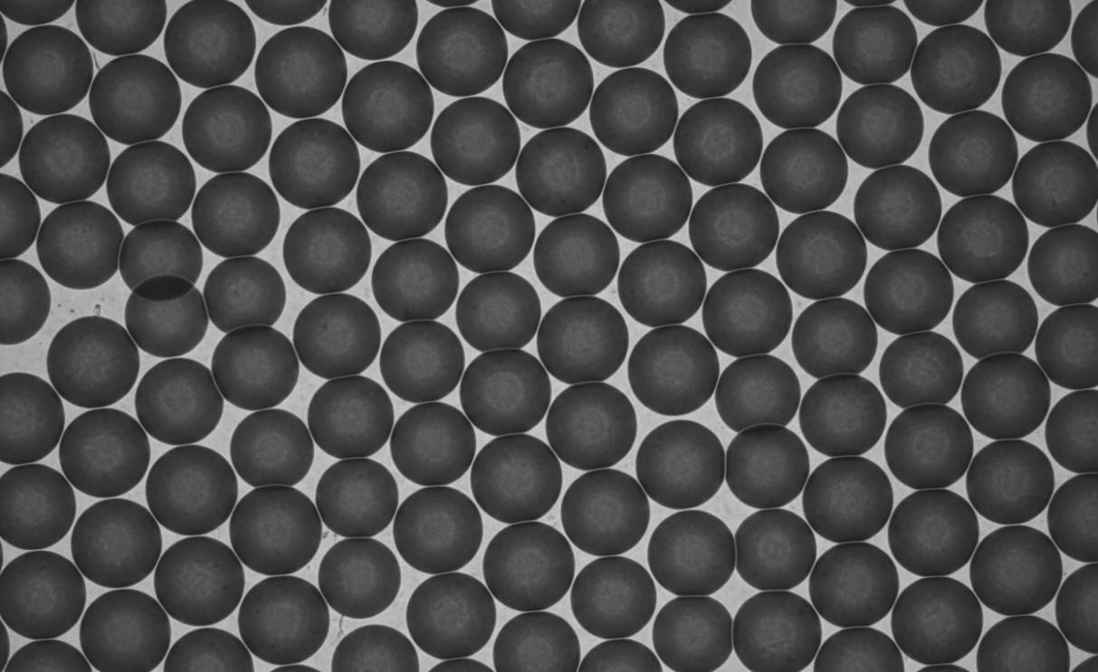 Monodisperse spherical silica nanoparticles in hexagonal close-packed arrangement.