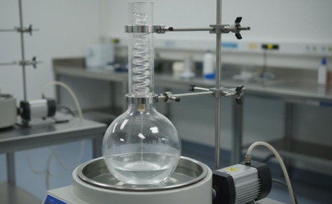 Rotary evaporator with round-bottom flask rotating in heated water bath for thin-film hydration preparation of liposomal drug carriers