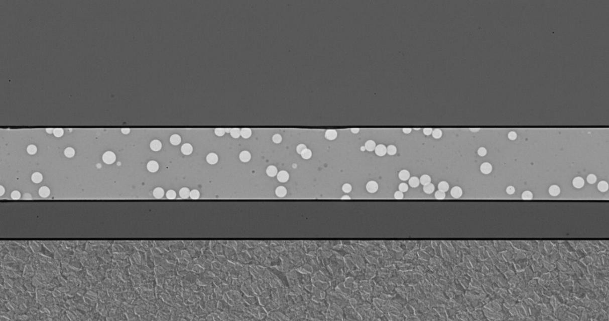 Cross-sectional SEM image of multilayer thin film stack on silicon substrate showing distinct functional layers