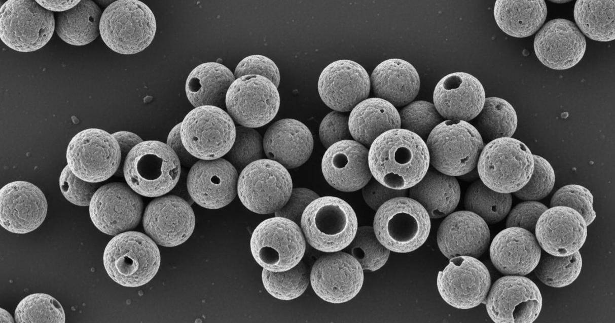 SEM image showing hollow silicon nanospheres with uniform size distribution and porous surface morphology for lithium-ion battery anode applications